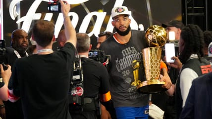 Jun 13, 2026; San Antonio, Texas, USA; New York Knicks (former Minnesota Timberwolves) center Karl-Anthony Towns (32) walks off the court with the trophy after the Knicks defeat the San Antonio Spurs during game five of the 2026 NBA Finals at Frost Bank Center. Mandatory Credit: Scott Wachter-Imagn Images