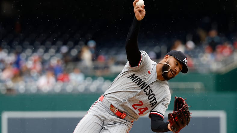 Simeon Woods Richardson falling over as he throws a pitch for the Minnesota Twins against the Washington Nationals