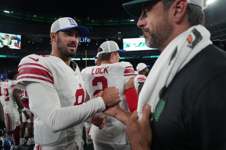 Former Minnesota Vikings quarterback Daniel Jones shaking hands with NY Jets QB Aaron Rodgers, while playing for the Giants.